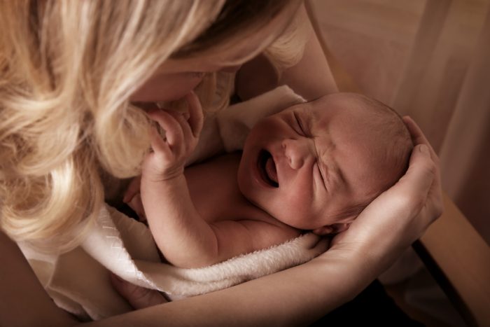 Mother Soothing A Crying Baby